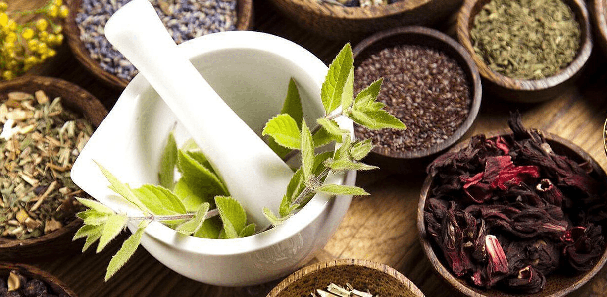 A mortar and pestle with herbs in it.