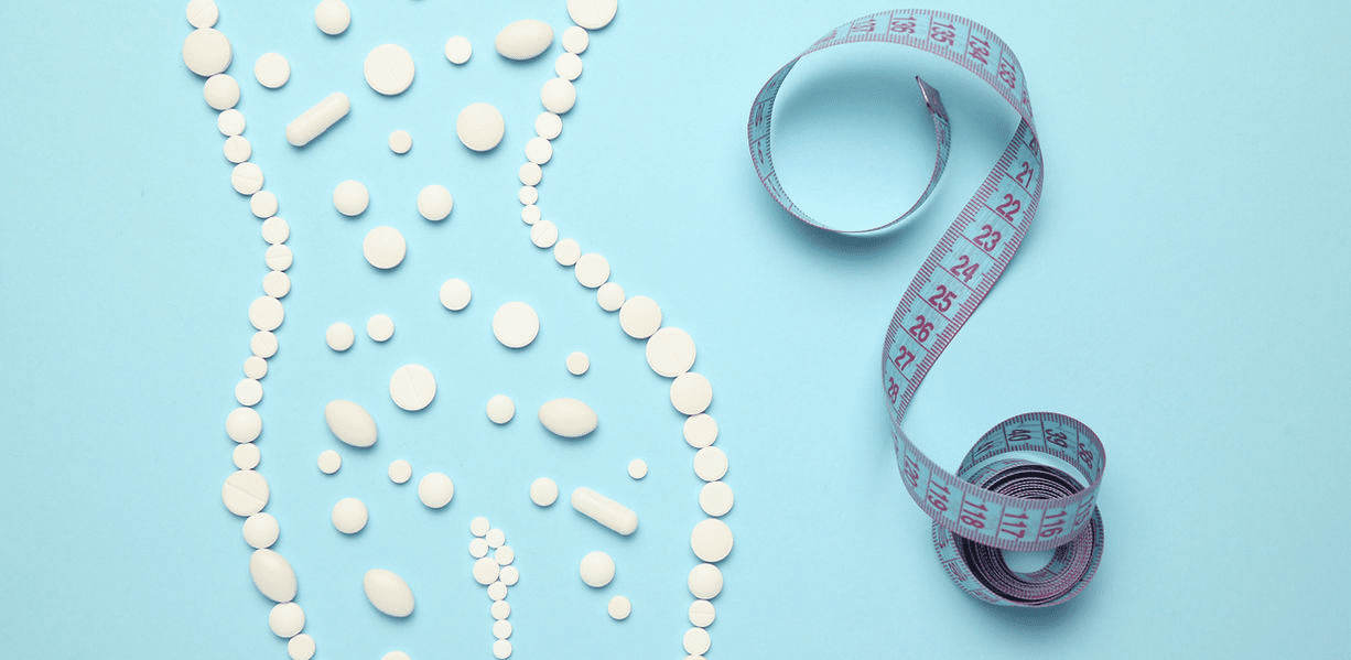 A blue table topped with white pills and tape.