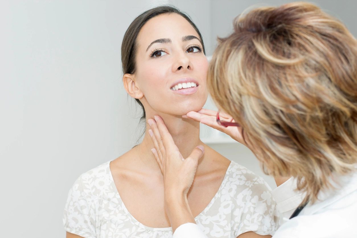 Mature female doctor examining her patient.