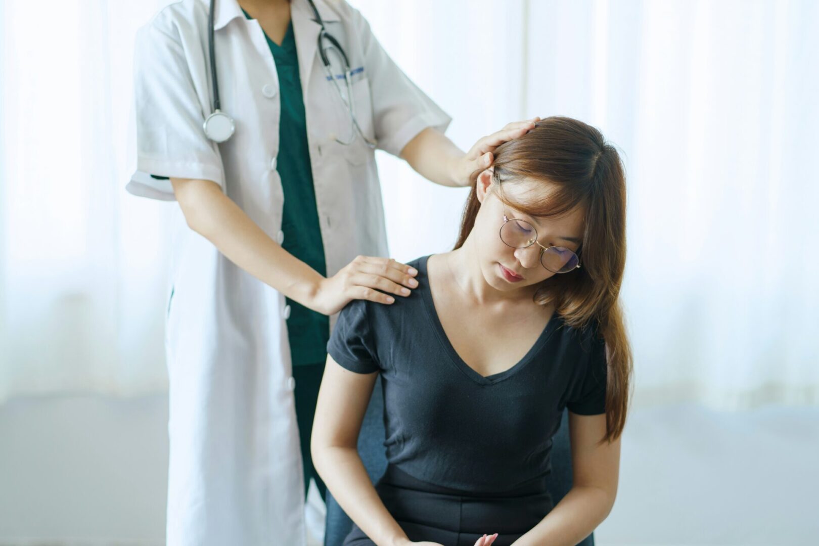 A woman at the doctor seeking relief for pain.