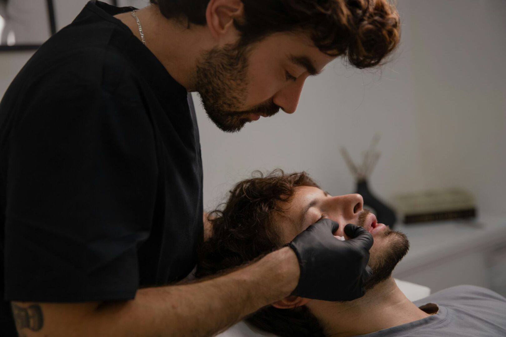 A man at the doctor getting facial aesthetics procedures.